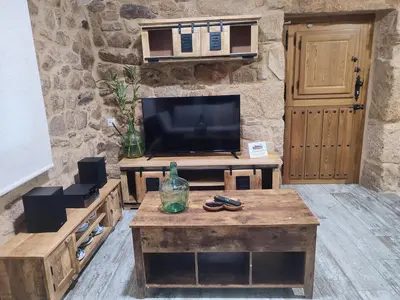 a living room with a tv and a coffee table at Casa Rústica O Abeiro in Pontevedra