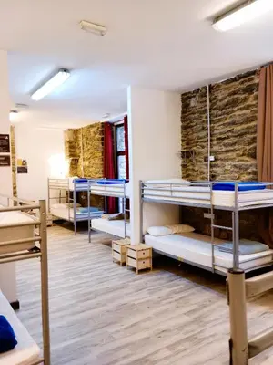 a group of bunk beds in a dorm room at Albergue San Lázaro in Sarria