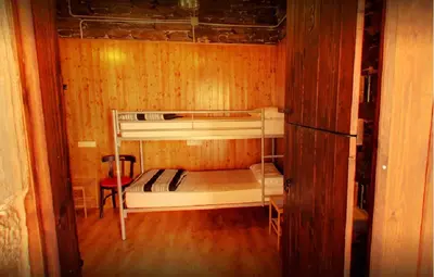a small room with two bunk beds in it at Albergue San Lázaro in Sarria