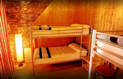 a room with two bunk beds in a cabin at Albergue San Lázaro in Sarria