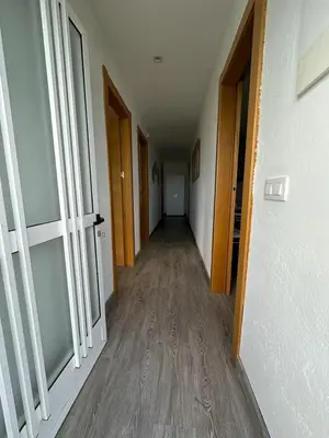 an empty hallway with wooden floors in an apartment at RECUNCHIÑO in San Xoán de Río