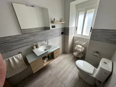 a bathroom with a sink and a toilet and a mirror at RECUNCHIÑO in San Xoán de Río