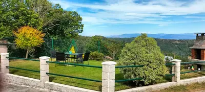 a view from the backyard of a house with a fence at RECUNCHIÑO in San Xoán de Río