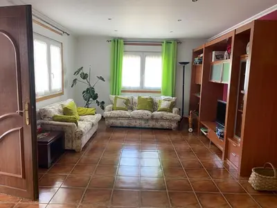 a living room with two couches and green curtains at Casa da Pinguela Camino Inglés in Ordes