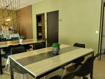 a conference room with tables and chairs and a vase on a table at Hostel Azul Cielo in O Pedrouzo