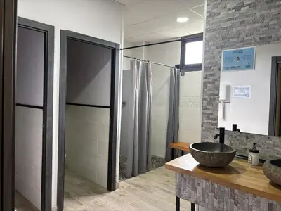 a bathroom with a sink and a shower at Hostel Azul Cielo in O Pedrouzo