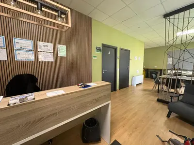 an office with a reception desk and a chair at Hostel Azul Cielo in O Pedrouzo