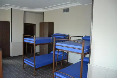 a group of bunk beds in a room with a window at Albergue Credencial in Sarria