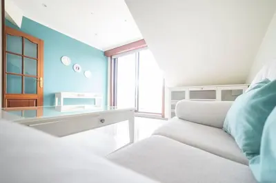 a living room with a white couch and a glass table at Apartamento Las Candelas, Ares in Ares
