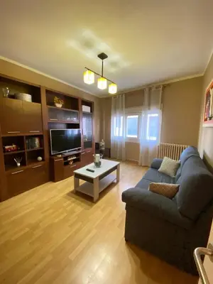 a living room with a blue couch and a coffee table at PISO EN ESTACION DE MONFORTE DE LEMOS in Monforte de Lemos