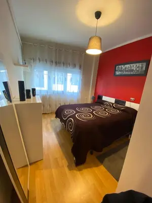 a bedroom with a black bed and a red wall at PISO EN ESTACION DE MONFORTE DE LEMOS in Monforte de Lemos