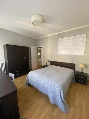 a bedroom with a large white bed and a window at PISO EN ESTACION DE MONFORTE DE LEMOS in Monforte de Lemos