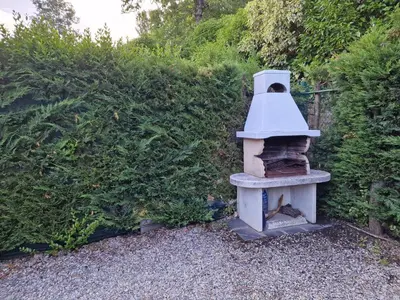 a bird house sitting on top of a gravel yard at El Descanso de Sanabria in Trefacio