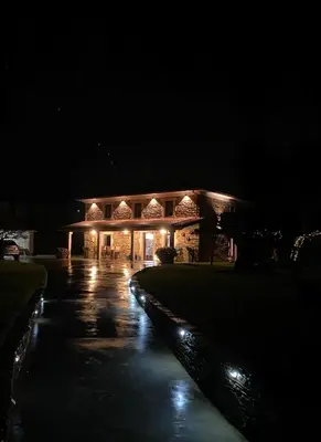 a building lit up at night with lights at Casa Fontes Rosas in Touro
