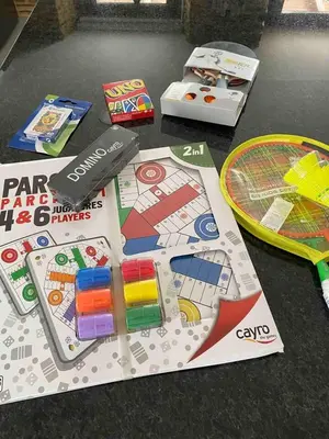 a table with a board game and a tennis racket at Casa Fontes Rosas in Touro