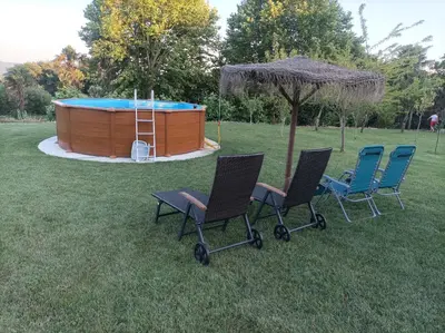 a group of chairs sitting in front of a hot tub at Casa Fontes Rosas in Touro