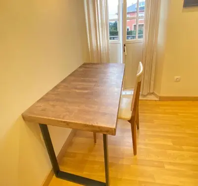 a wooden table and a chair in a room at Casa Outeiro in Betanzos