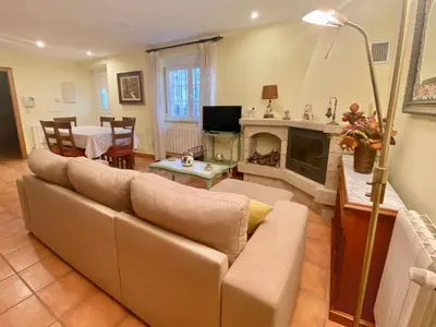 a living room with a couch and a fireplace at Casa Outeiro in Betanzos