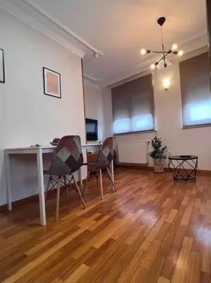 a living room with a table and two chairs at Apartamento Cantabrico vistas a la Ría deRibadeo in Ribadeo
