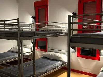 a bunk bed room with three bunk beds in it at ALBERGUE A POBRA DO BROLLON in Puebla del Brollón