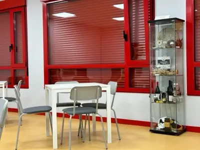 a dining room with a white table and chairs at ALBERGUE A POBRA DO BROLLON in Puebla del Brollón