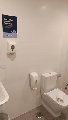 a white bathroom with a toilet and a sink at Pensión SP 55 by Bossh! Hotels in Santiago de Compostela