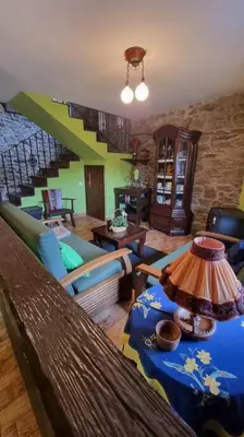 a living room with a couch and a table at Casa Rural Maria de Isidro in Caboalles de Arriba