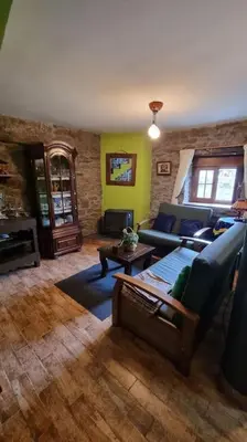 a living room with a couch and a table at Casa Rural Maria de Isidro in Caboalles de Arriba