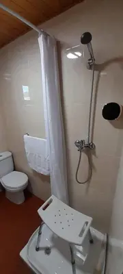 a small bathroom with a shower and a toilet at La Huella del Peregrino - Ionut Preda in Palas de Rei