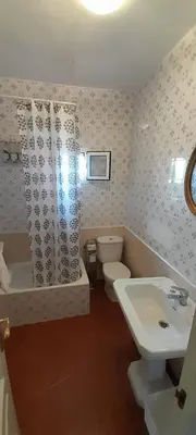 a bathroom with a sink and a tub and a toilet at La Huella del Peregrino - Ionut Preda in Palas de Rei