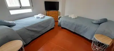 a room with two beds and a tv in it at La Huella del Peregrino - Ionut Preda in Palas de Rei