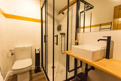 a bathroom with a toilet and a sink and a shower at hostal Nomade Santiago in Santiago de Compostela