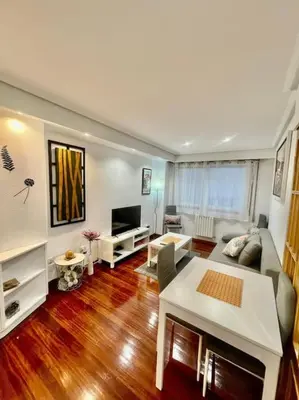 a living room with a couch and a table at Curros Enríquez MR in Ourense