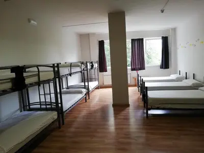 a group of bunk beds in a room at Alma del Camino - Rooms & Albergue in Sarria