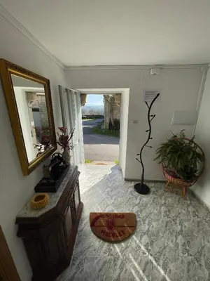 a living room with a mirror and a table at A Casa da Torre Peruscallo in Belante