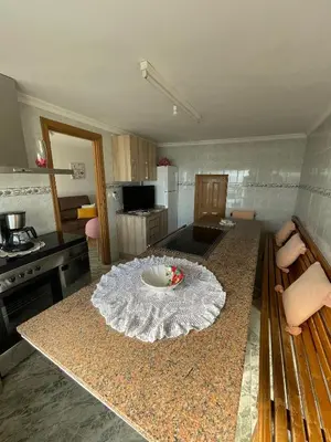 a kitchen with a table in the middle of it at A Casa da Torre Peruscallo in Belante