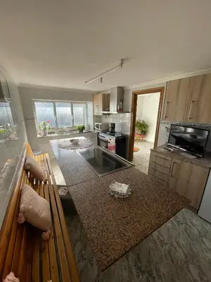 a kitchen with a table and a counter top at A Casa da Torre Peruscallo in Belante
