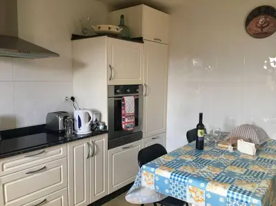 a kitchen with a table with a bottle of wine at Casa da Forxa, renovated former forge/ smithy in Lugo