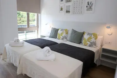 a bedroom with two beds with towels on them at Pedro Luxury in Padrón