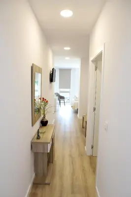 a room with a hallway with a table and a mirror at Pedro Luxury in Padrón