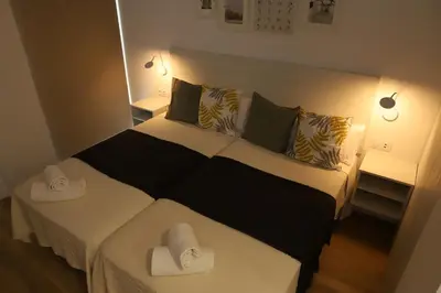 a bedroom with a black and white bed with two pillows at Pedro Luxury in Padrón