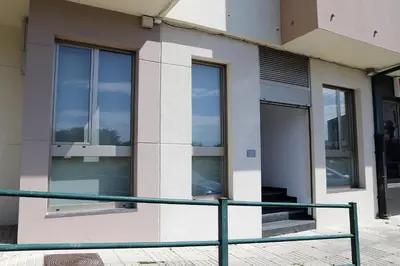 a facade of a building with glass windows at Pedro Luxury in Padrón