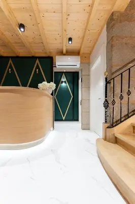 a lobby with a reception desk and a green door at Hostal HCELENIS in Caldas de Reis