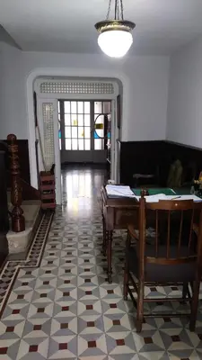 a living room with a table and a floor at Pension-Albergue Don Alvaro in Sarria
