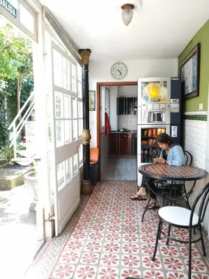 a man sitting at a table in a room at Pension-Albergue Don Alvaro in Sarria
