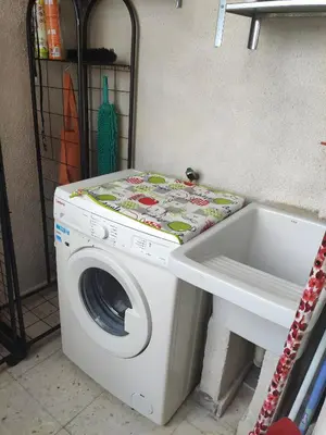 a washing machine sitting next to a sink at Casa JRM 'Ribeira Sacra' in Monforte de Lemos
