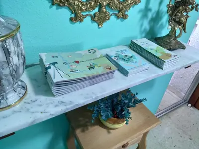 three books sitting on a table next to a mirror at Casa JRM 'Ribeira Sacra' in Monforte de Lemos