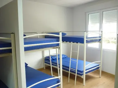 a bunk bed room with four bunk beds at Pensión-Albergue Puente Ribeira in Sarria