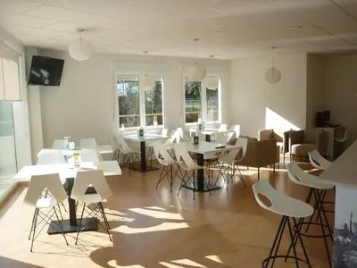 a room with white tables and chairs and windows at Pensión-Albergue Puente Ribeira in Sarria