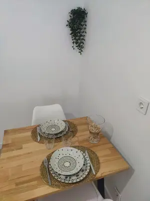 a wooden table with plates and dishes on it at O Lar da Muralla in Lugo